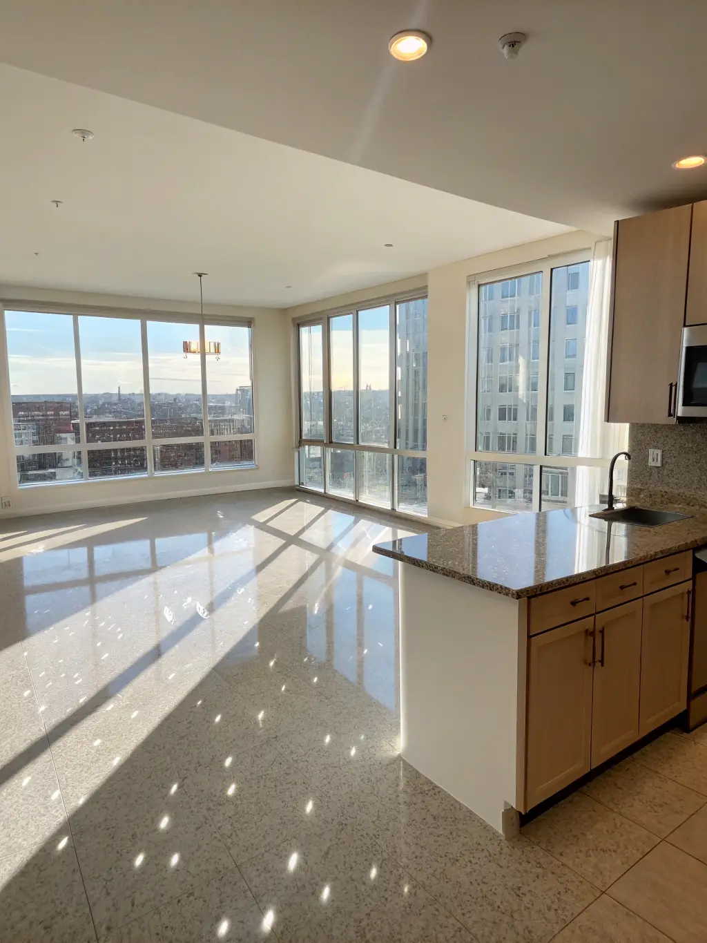 An empty, freshly cleaned apartment with spotless floors and windows, ready for new occupants after a move-out cleaning service by Priscila sparkle cleaning.